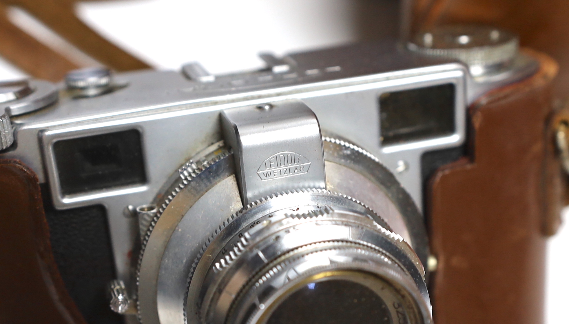 A Lordomat leather cased camera, lenses, flashgun, tripod and larger camera case